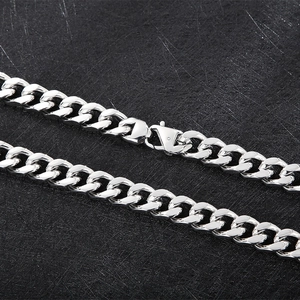 Macro detail of 14mm silver titanium steel Cuban link chain with secure lobster clasp