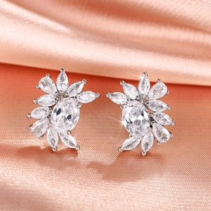 Macro detail of silver flower earrings with oval and marquise cubic zirconia stones
