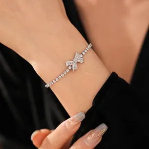 Elegant adjustable silver bracelet with a sparkling zircon bow charm and tennis chain style