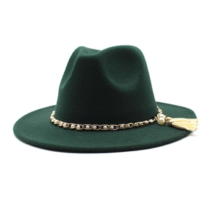 Close-up of gold chain with pearls and tassel detail on dark green wool fedora hat