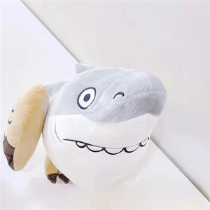 Detail of funny shark plush toy with playful winking expression and soft gray fabric