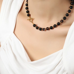 Natural black agate bead necklace with gold OT toggle clasp on model