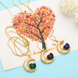 Detailed view of heart-shaped zircon pendants with emerald, onyx, and sapphire colors