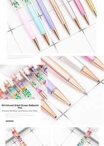 Detail of oil-filled pens with colorful dried flowers and rose gold metal components