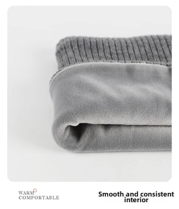 Macro detail of gray knitted neck warmer showing thick thermal fleece lining and soft texture