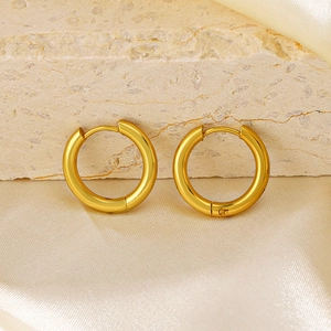 Minimalist 18K gold-plated geometric round hoop earrings on beige stone and silk background