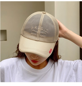 Detail of breathable mesh texture and premium embroidery on a beige summer sun hat