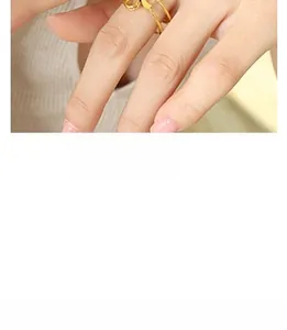 Close-up of a double-row gold ring featuring colorful zircon pavé set on a woman's finger