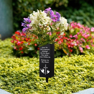 Memorial cemetery flower vase with cross and dove pattern on green grass background