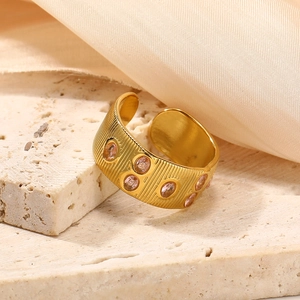 Golden titanium steel open ring with pink zircon stones and vertical striped texture
