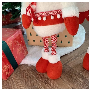 Close-up of plush Santa doll legs with red and white stripes and thick red boots