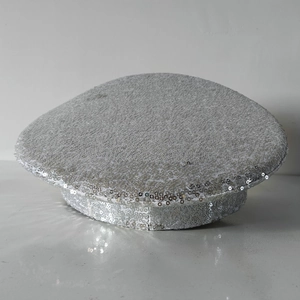 Detailed view of silver sequin embellished captain hat with shimmering flat top design