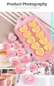 Macro detail of pink heart-shaped cookie cutters with LOVE and KISS embossed patterns