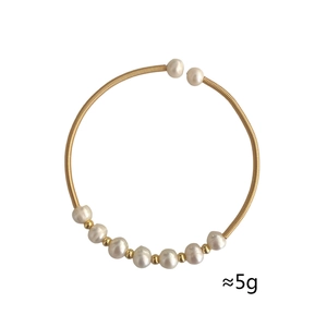 Detail of gold spiral wire bracelet with eight white pearls and golden beads, weighs 5g