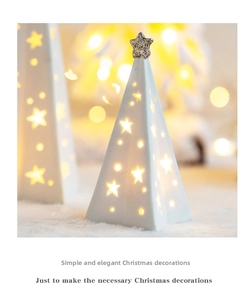 Close-up of a white ceramic Christmas tree lamp with hollow star cutouts and silver top star