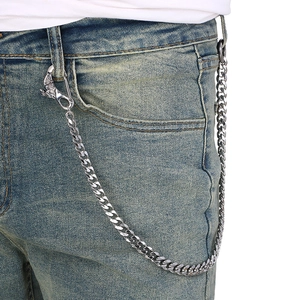 Detail of gothic stainless steel wallet chain with animal head clasp on denim jeans