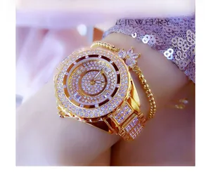 Close-up of luxury gold-tone watch with rhinestones and matching butterfly bracelet