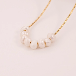 Minimalist freshwater pearl necklace with 7 white pearls on a gold plated 18k chain