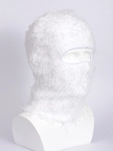 Detail of white plush knitted balaclava mask with soft fuzzy texture for winter warmth