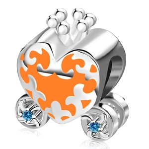 Macro shot of silver heart carriage charm with orange enamel patterns and blue stone wheels