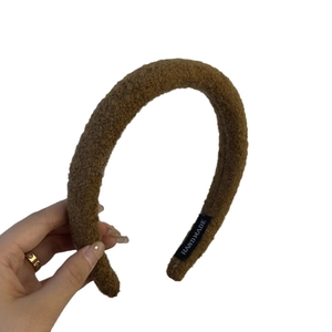 Brown plush sponge headband with high top texture and handmade woven label
