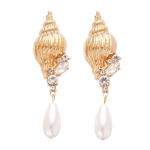 Gold conch earrings with sparkling rhinestones and teardrop pearls on a clean background