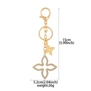 Detailed view of rhinestone clover keychain with dimensions 15cm height and 5.2cm width