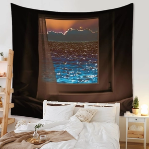 Detail of bohemian tapestry showing a realistic night seascape with moon on a bedroom wall