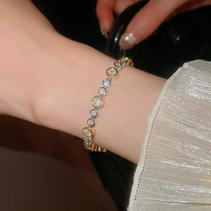 Detail of a luxury stainless steel bracelet with shell stars and floral crystal links