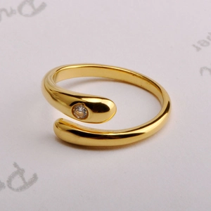 Close-up of gold-plated snake wrap ring featuring a sparkling round zircon stone