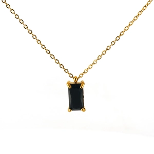 Detail of 18K gold stainless steel chain with a four-prong set black rectangular zircon pendant