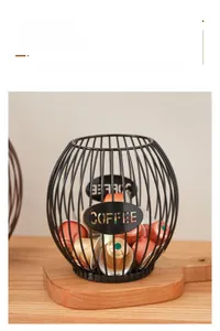 Close-up of black iron coffee capsule basket with hollow metal COFFEE letter sign