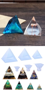 Detailed view of pyramid silicone resin molds with dried flower and crystal stone inserts