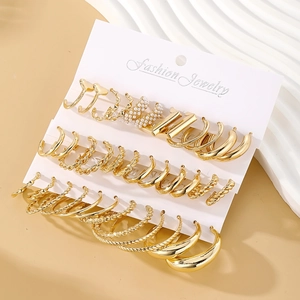 Detail of 16-piece gold earring set with pearls and twisted designs on a display card