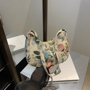 Chic beige corduroy underarm bag featuring colorful floral prints and a crescent shape