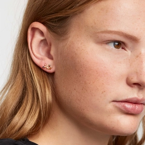 Elegant gold constellation stud earrings with multicolored cubic zirconia on female model