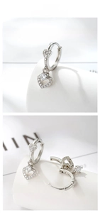 Detailed view of silver heart-shaped zircon earrings with elegant drop pendants