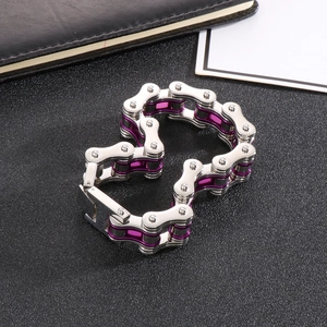 Industrial stainless steel bike chain bracelet with purple accents on dark background