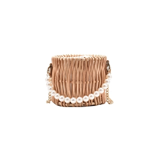 Handmade woven straw bucket bag with pearl handle and golden chain strap in white