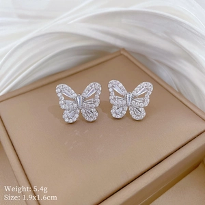 Macro shot of silver butterfly stud earrings with sparkling cubic zirconia stones