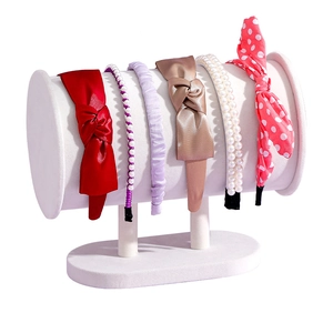 White velvet headband display stand with various stylish hair accessories for organization
