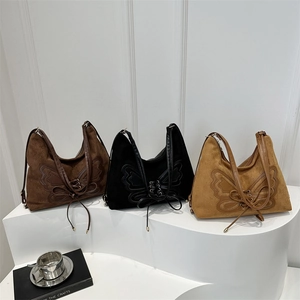 Three embroidered butterfly tote bags in brown, black, and camel with adjustable straps