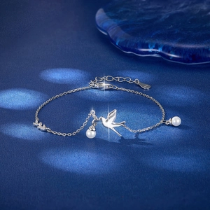 Elegant S925 sterling silver bird bracelet with white pearls and sparkling zircon accents