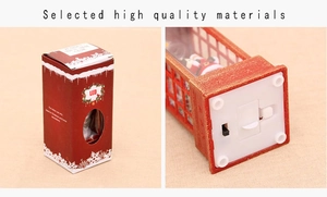 Detail of Christmas lantern base with battery compartment and festive gift packaging