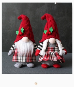 Detail view of male and female Christmas gnomes with plaid outfits and knit hats