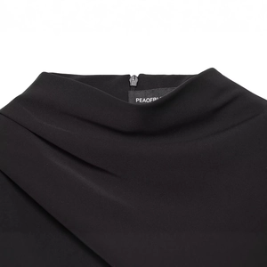 Short black dress featuring a sophisticated pleated neckline with a hidden back zipper