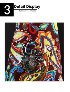 Close-up of spider brooch in antique silver alloy with detailed metal texture on silk