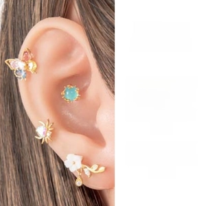 Macro shot of stainless steel earring set with colorful zircon butterfly and flower designs