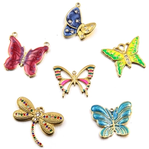Detail of colorful enamel butterfly and dragonfly charms with rhinestones for DIY jewelry