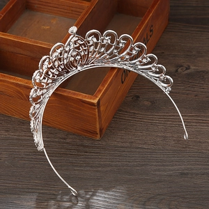 Macro shot of silver wedding crown with sparkling rhinestones on vintage wood surface
